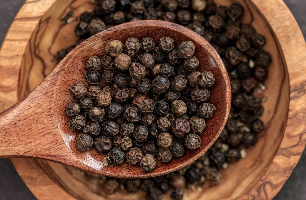Natural whole black peppercons used for cooking and seasoning